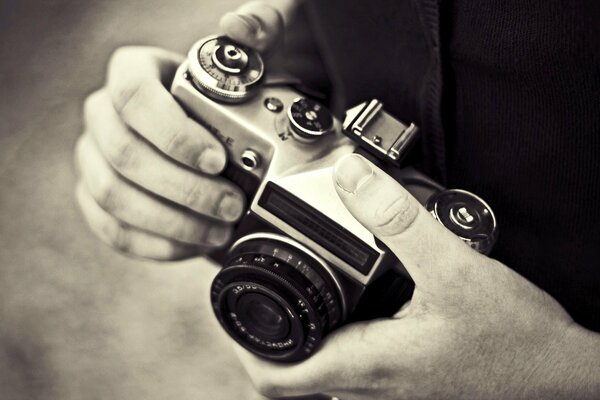Black and white photo of the camera in the hands