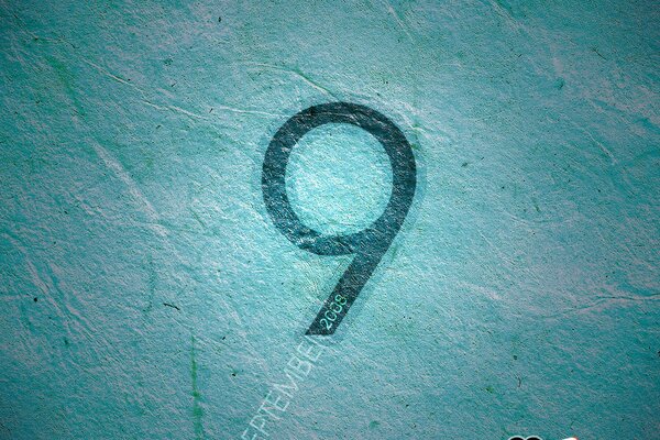 Black number nine on a blue background