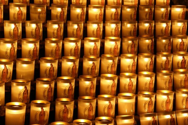 There are many burning candles in the temple