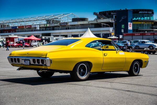 Classic yellow chevrolet caprice on the roads of the city