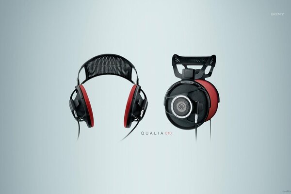 Red and black headphones on a gray background