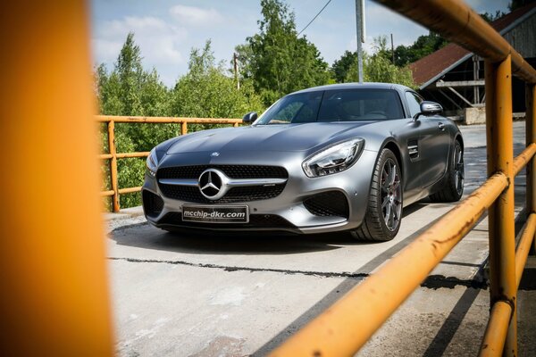 Silver Mercedes on a pedestrian bridge