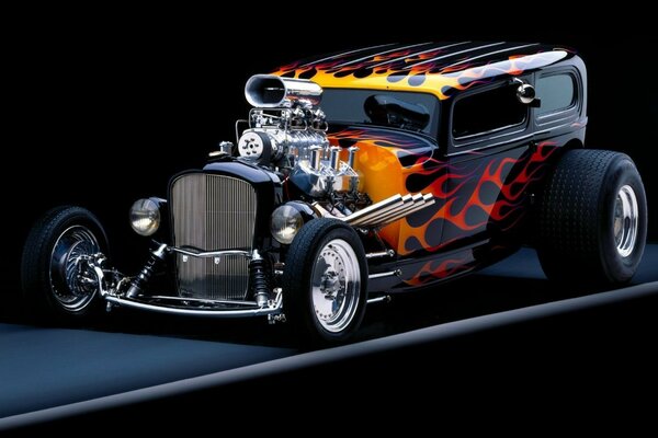 Retro car with a fiery pattern on a dark background