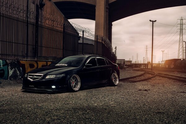 Black expensive foreign car on the background of sunset