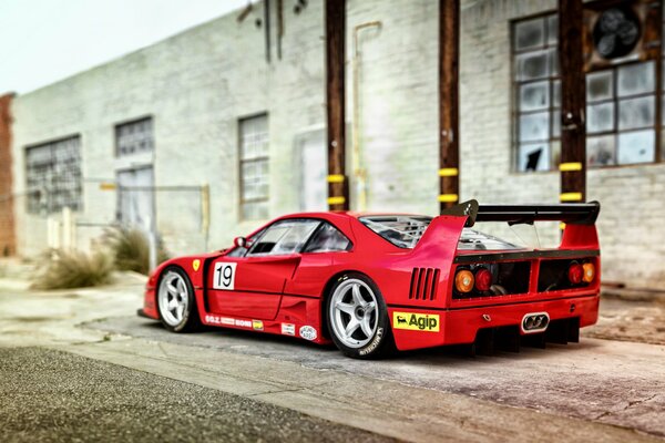 Red Ferrari f40, rear view, street location