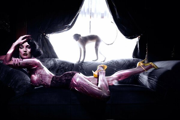 A female model on a sofa in purple tones