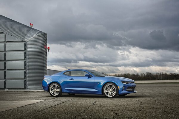 Blue chevrolet camaro pc 2015 on the background of a stormy sky