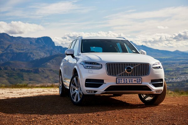 A white Volvo on a deserted road