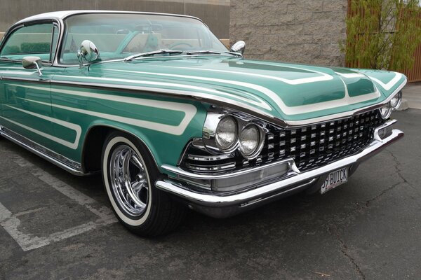 Green classic retro car in the parking lot