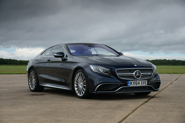 Black Mercedes on a gray sky background