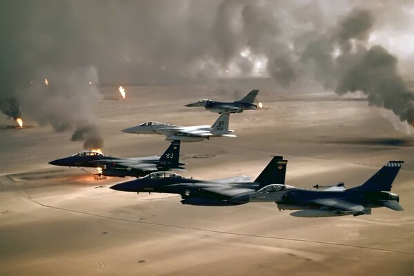 Military planes fly over the desert