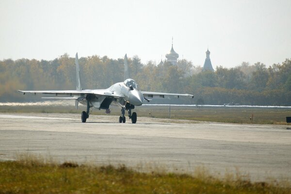 The military fighter jet on the highway is ready to fly