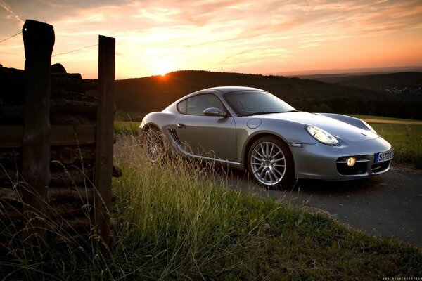 Grey Porsche cayman at sunset