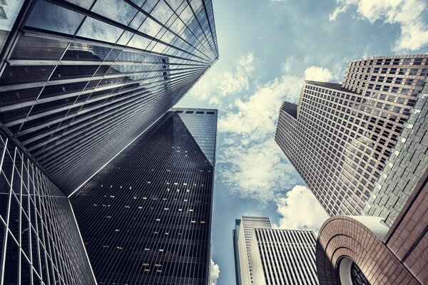 A skyscraper in a city under a blue sky