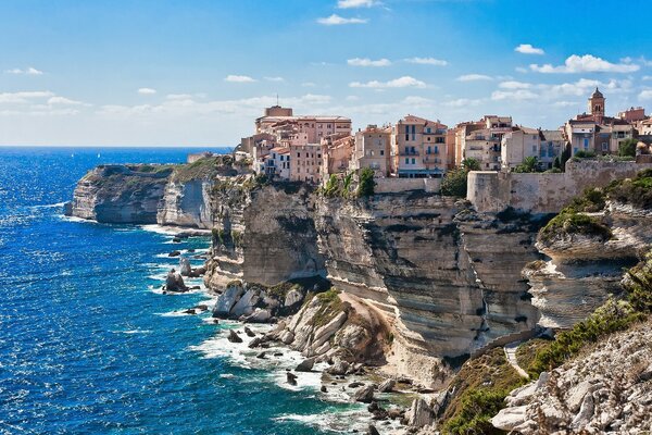 The blue sea and houses on the rocks