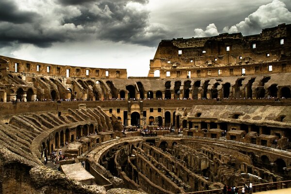 Historical ruins of the Colosseum with tourists