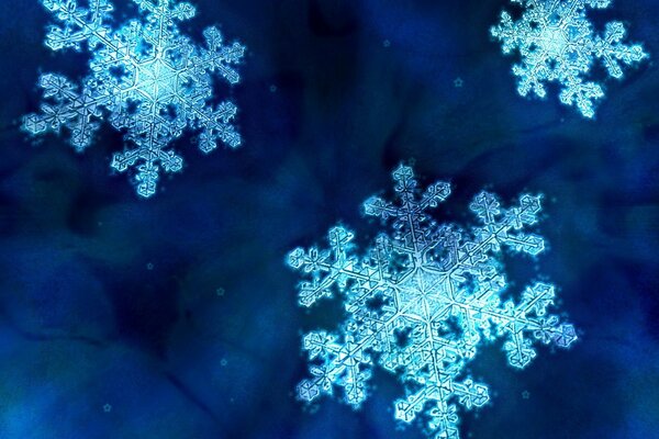 Schöne Schneeflocken auf blauem Hintergrund