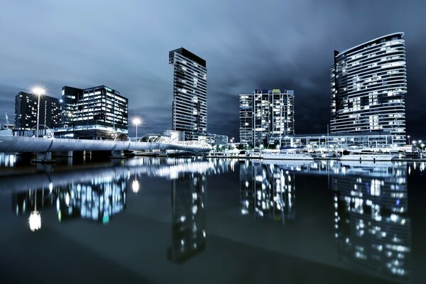 Night city, lights of skyscrapers are burning