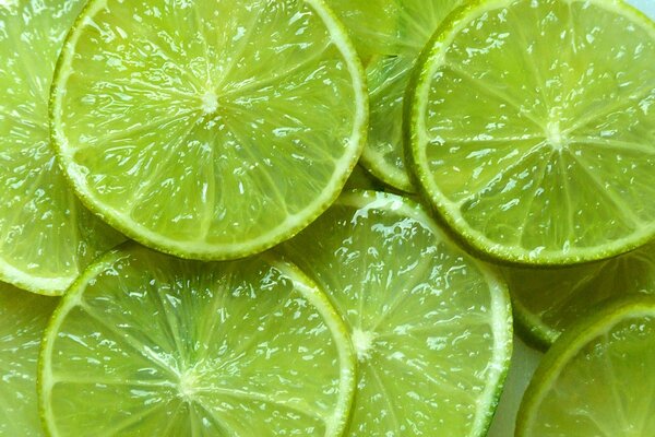 Carta da parati con fette di lime verde brillante