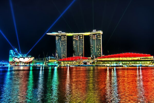 Радужное отражение на воде огней казино в Сингапуре