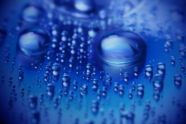 Blue water drops are flowing down