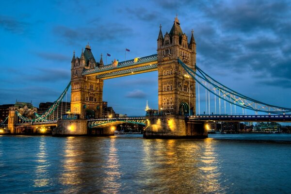 Illuminated bridge with towers across the Thames