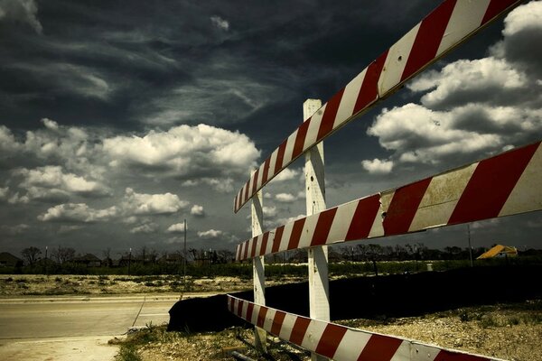 Turn of the road on the background of cloudy sky