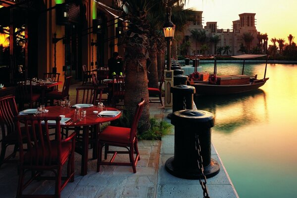 Terrace cafe on the water at sunset