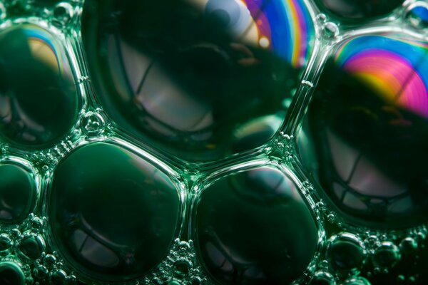 Rainbow of green soap bubbles