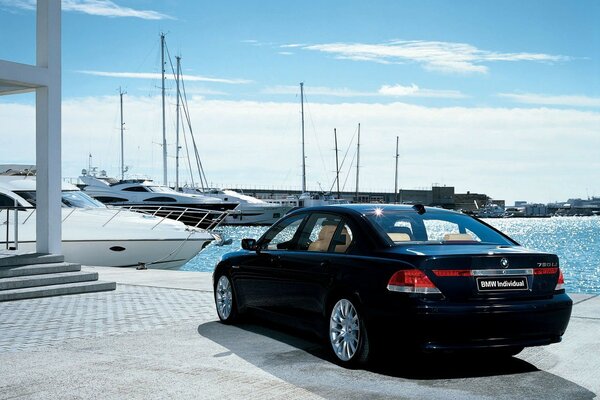 Black BMW on the background of yachts and clear blue sky