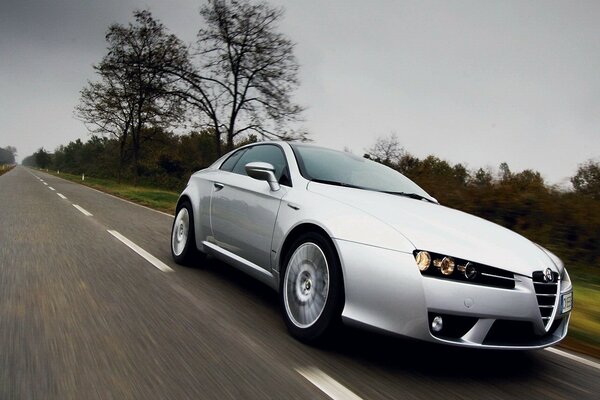 Silver car in motion in cloudy weather