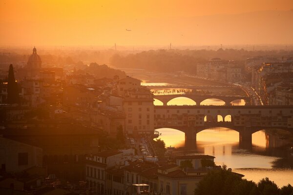 A bright river under the bridges at sunset