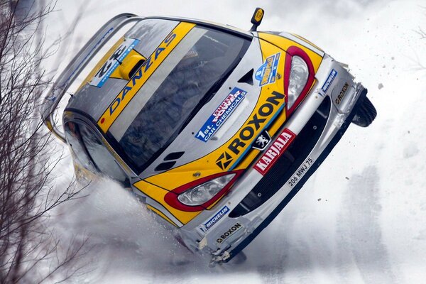 A racing car on a skid on a snow-covered track