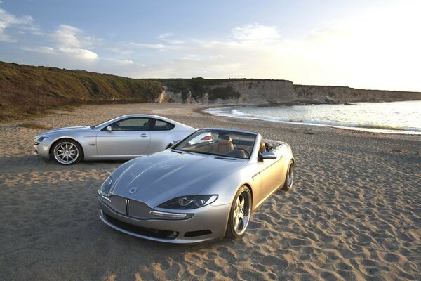 Две серебряных машины на песчаном пляже