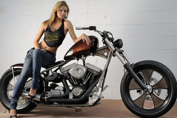 Blonde sitting on a harley davidson motorcycle