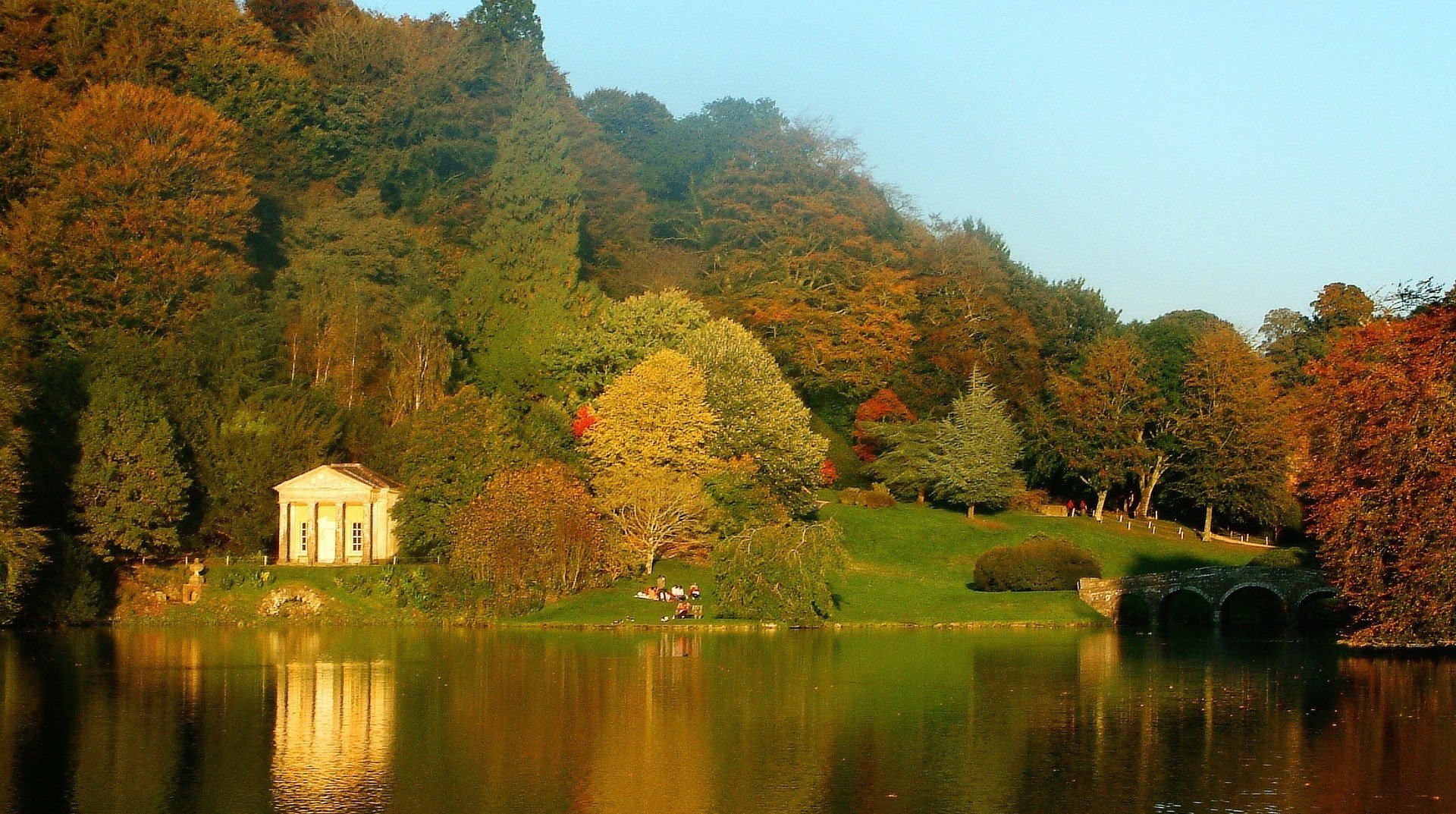 the bridge of stone mountain landscape the house on the lake lake house forest falling leaves golden time indian summer yellow leaves the colors of autumn surface reflection greens hill