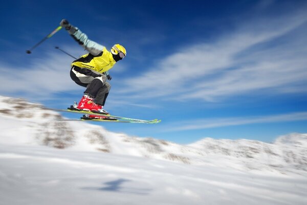 The snowboarder is flying down the slope