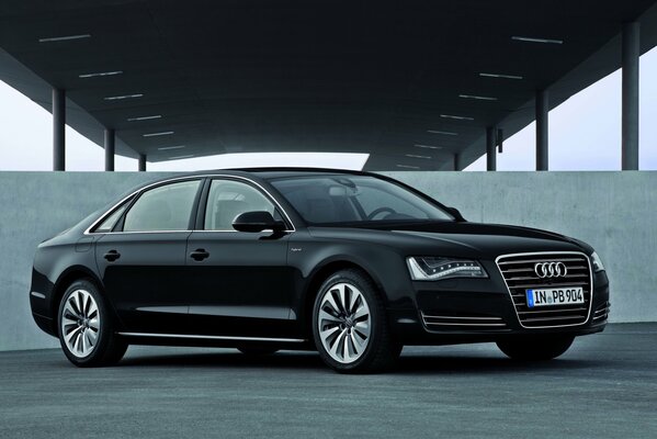 Black Audi A8 sedan on a concrete wall background