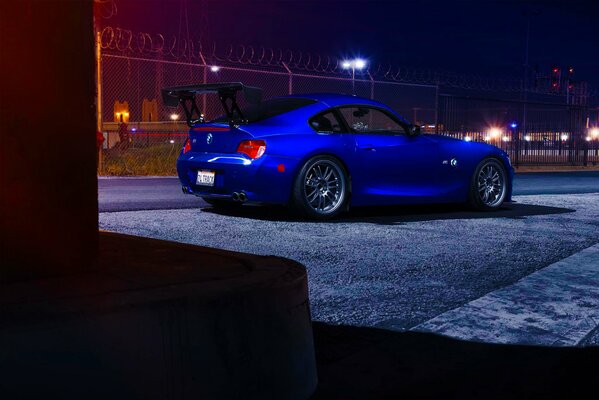 Blue BMW in the lights of the night city