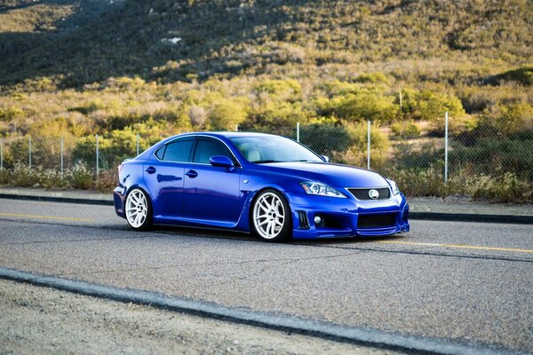 Blue Lexus rushes down the road