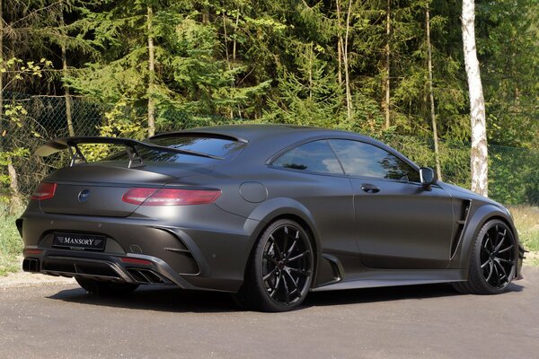 Mercedes-benz on a forest road on a sunny day