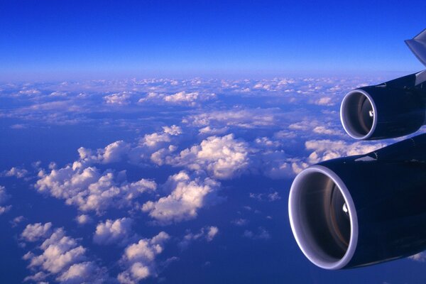 Turbines of an airplane flying above the clouds