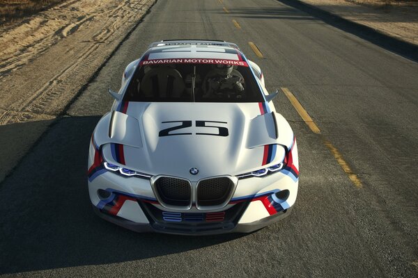BMW with the number 25 on the hood is driving on the road