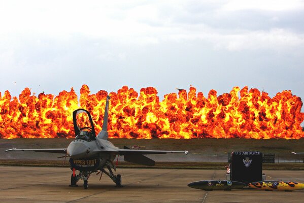 A fighter jet at the airfield. Fire and napalm