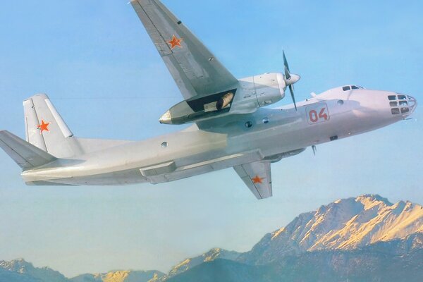 The Soviet AN30 plane flies in the sky over the mountains