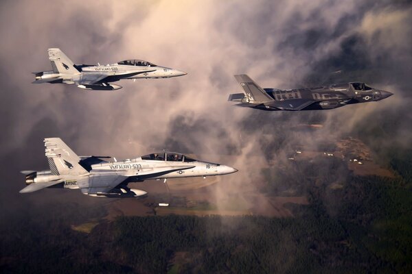 Three planes are flying in dark clouds