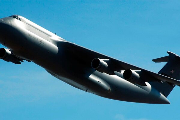 Black military aircraft galaxy on a blue sky background