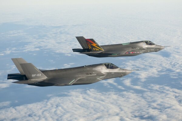 Lockheed Martin, cinquième génération de chasseurs, bombardiers en vol, au-dessus du sol