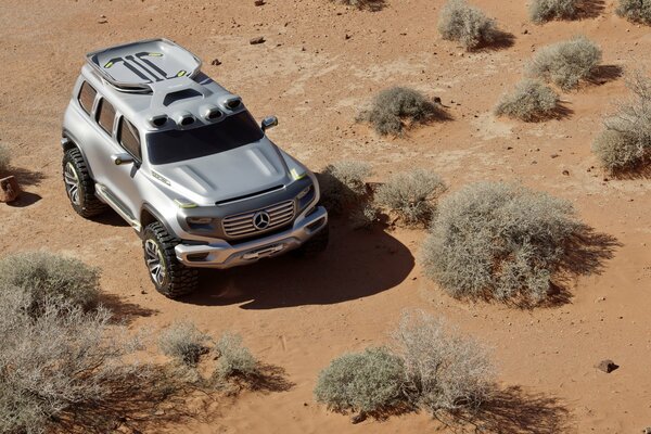 Mercedes benz SUV in the desert in a sea of sand