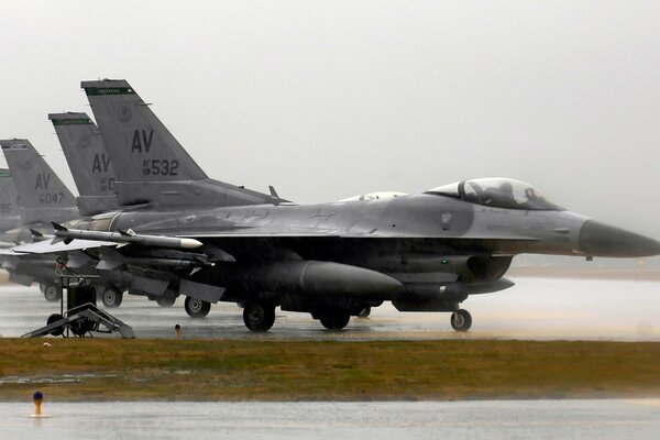 Military fighter in the rain at the base